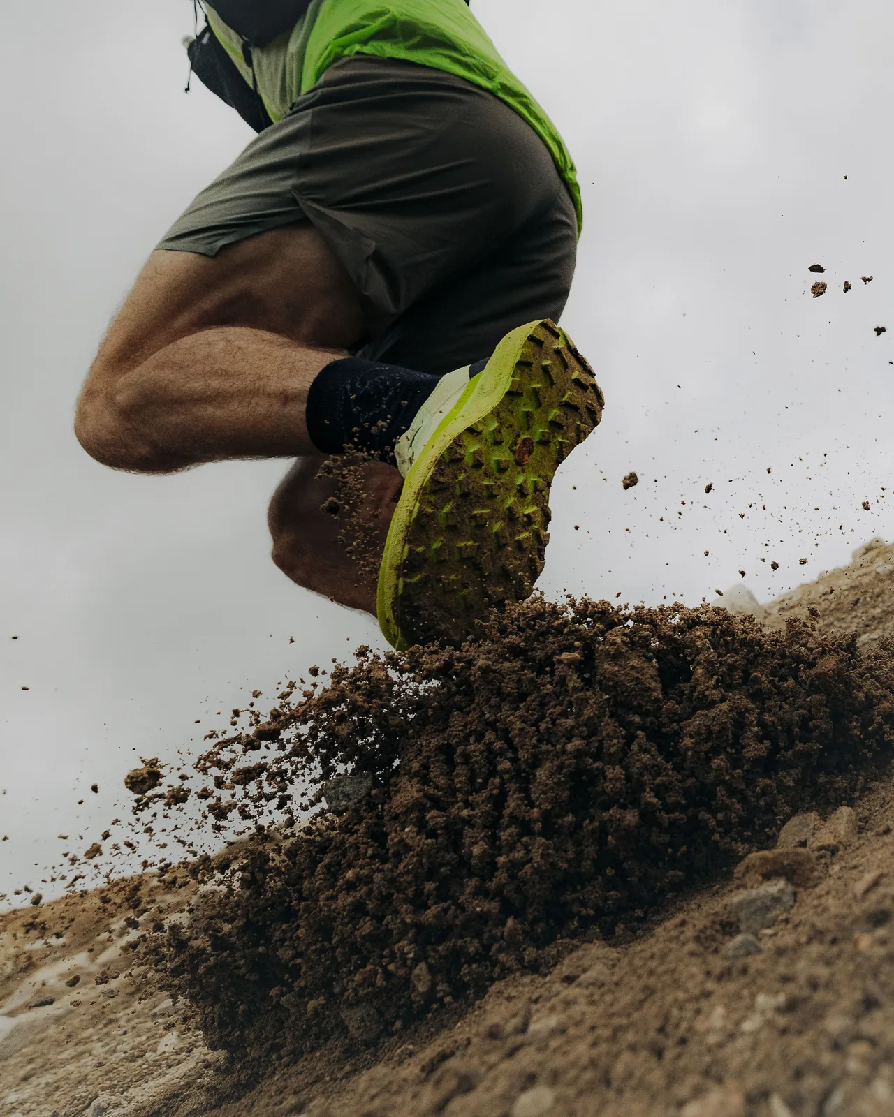 A trail shoe kicking up dirt