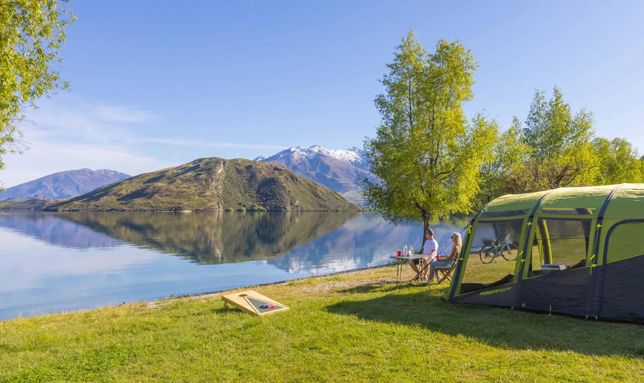 Family camping lakeside with a Zempire air tent
